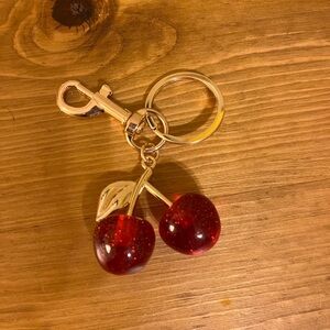 Red cherry keychain/bag tag on a gold tone chain 3 inches long